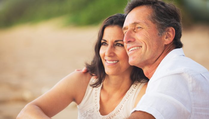 Happy Romantic Mature Couple Enjoying Sunset on the Beach
